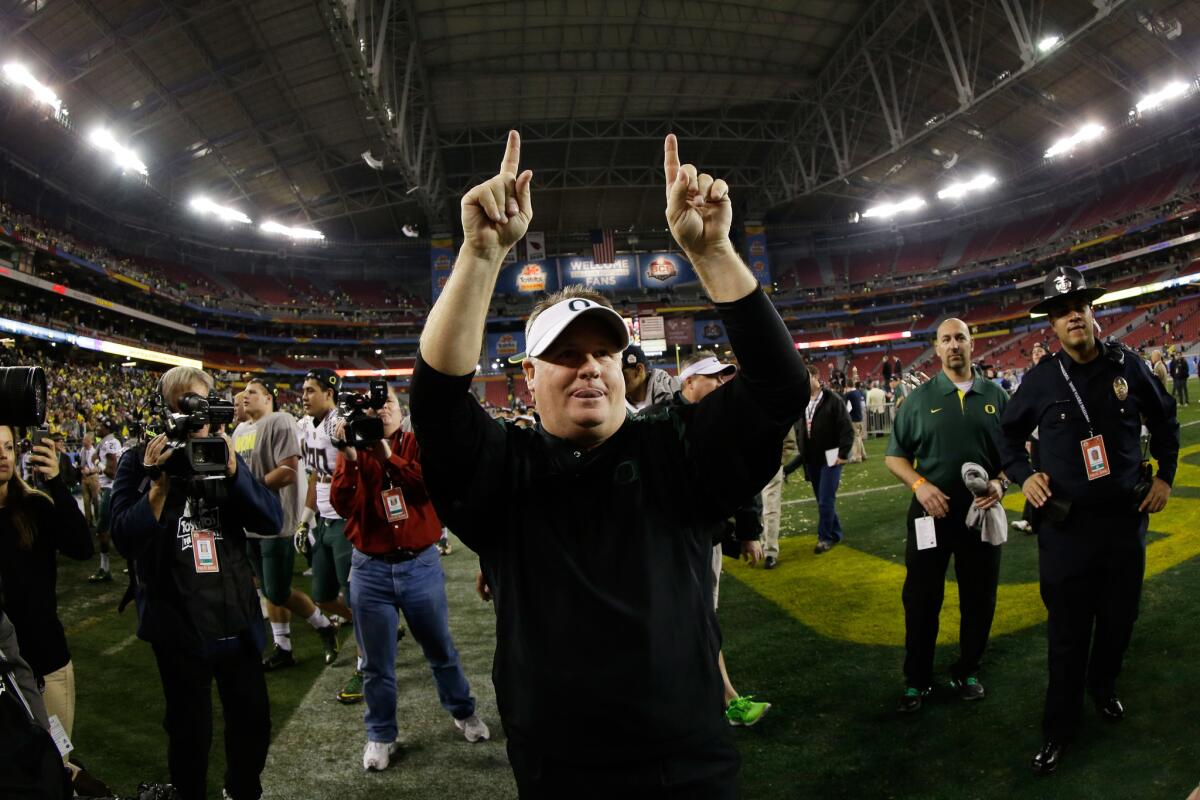 Coach Chip Kelly celebrates after Oregon defeated Kansas State, 35-17, to win the Fiesta Bowl at University of Phoenix Stadium on Jan. 3, 2013.