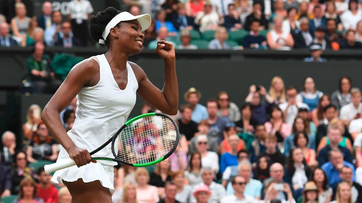 Venus Williams celebrates after beating Jelena Ostapenko in their women's singles quarterfinal match at Wimbledon on July 11.