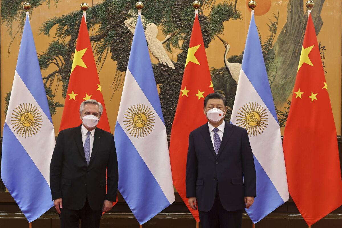 FILE - In this photo released by Xinhua News Agency, Chinese President Xi Jinping, right, and Argentina's President Alberto Fernandez pose for a photo before their bilateral meeting at the Great Hall of the People in Beijing, Sunday, Feb. 6, 2022. A joint statement issued following a meeting in Beijing Sunday between Xi and Fernandez stated that “China reaffirms its support for Argentina’s demand for the full exercise of sovereignty over the Malvinas Islands,” using the Argentine name for the islands. (Liu Weibing/Xinhua via AP, File)