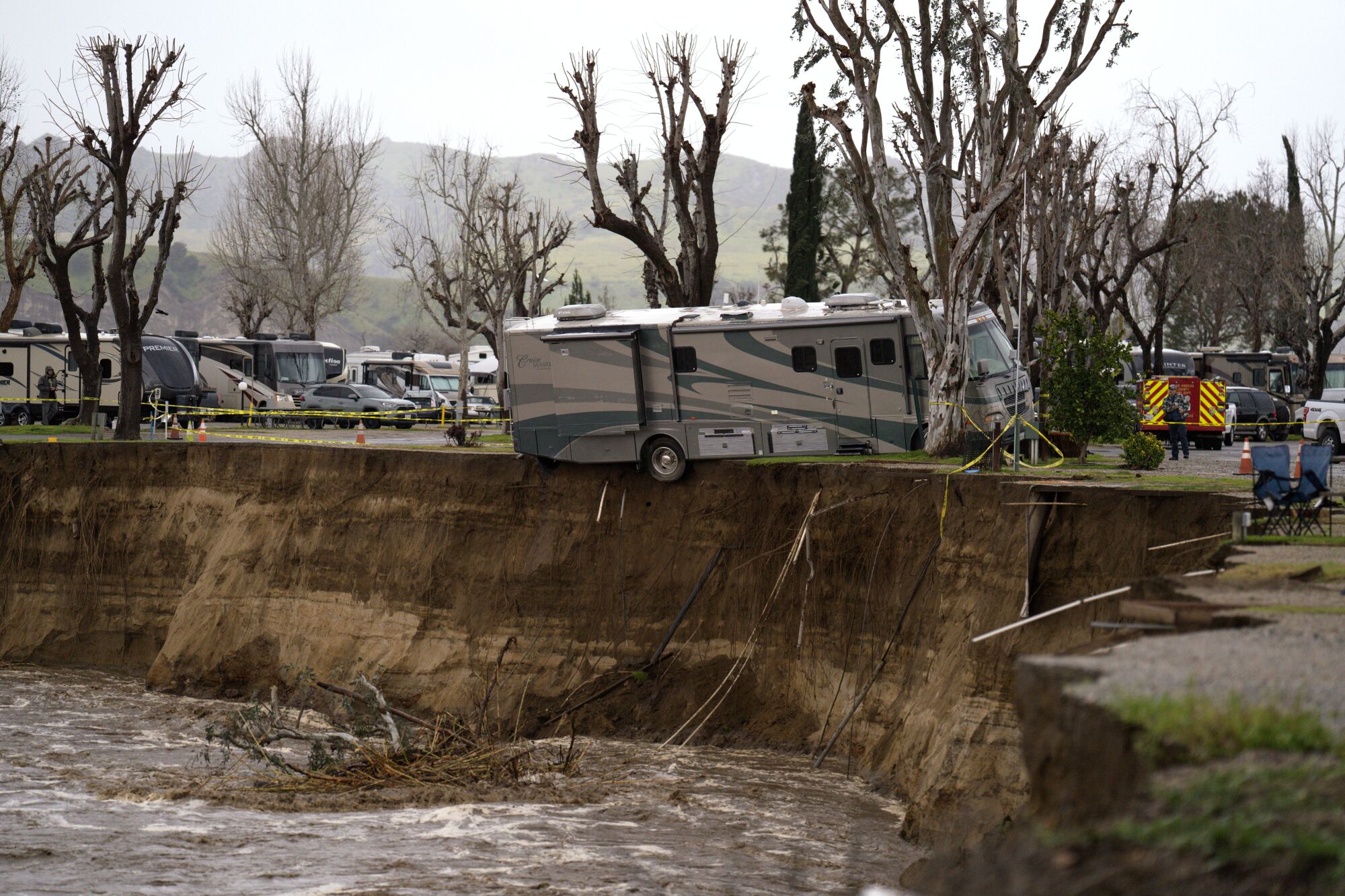 An RV on the edge of an eroded riverbank at the Valencia Travel Village RV Park in Castaic.