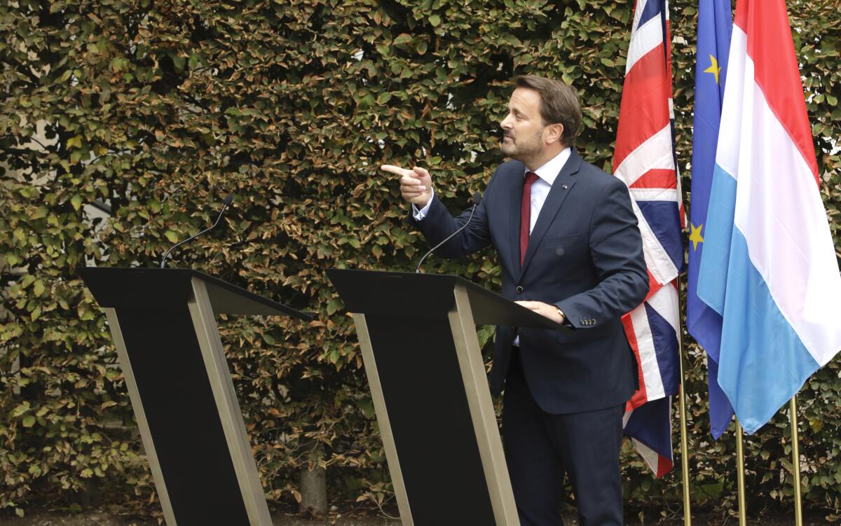 Prime Minister Xavier Bettel of Luxembourg addresses a news conference next to an empty lectern intended for British Prime Minister Boris Johnson after a meeting at the prime minister's office in Luxembourg on Sept. 16, 2019.