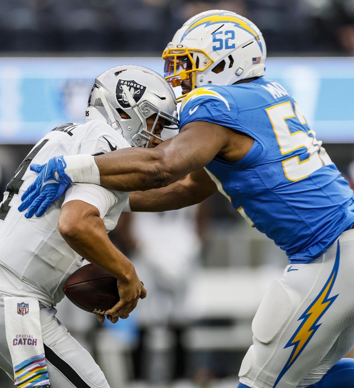 Chargers linebacker Khalil Mack (52) sacks the Raiders' Aidan O'Connell.