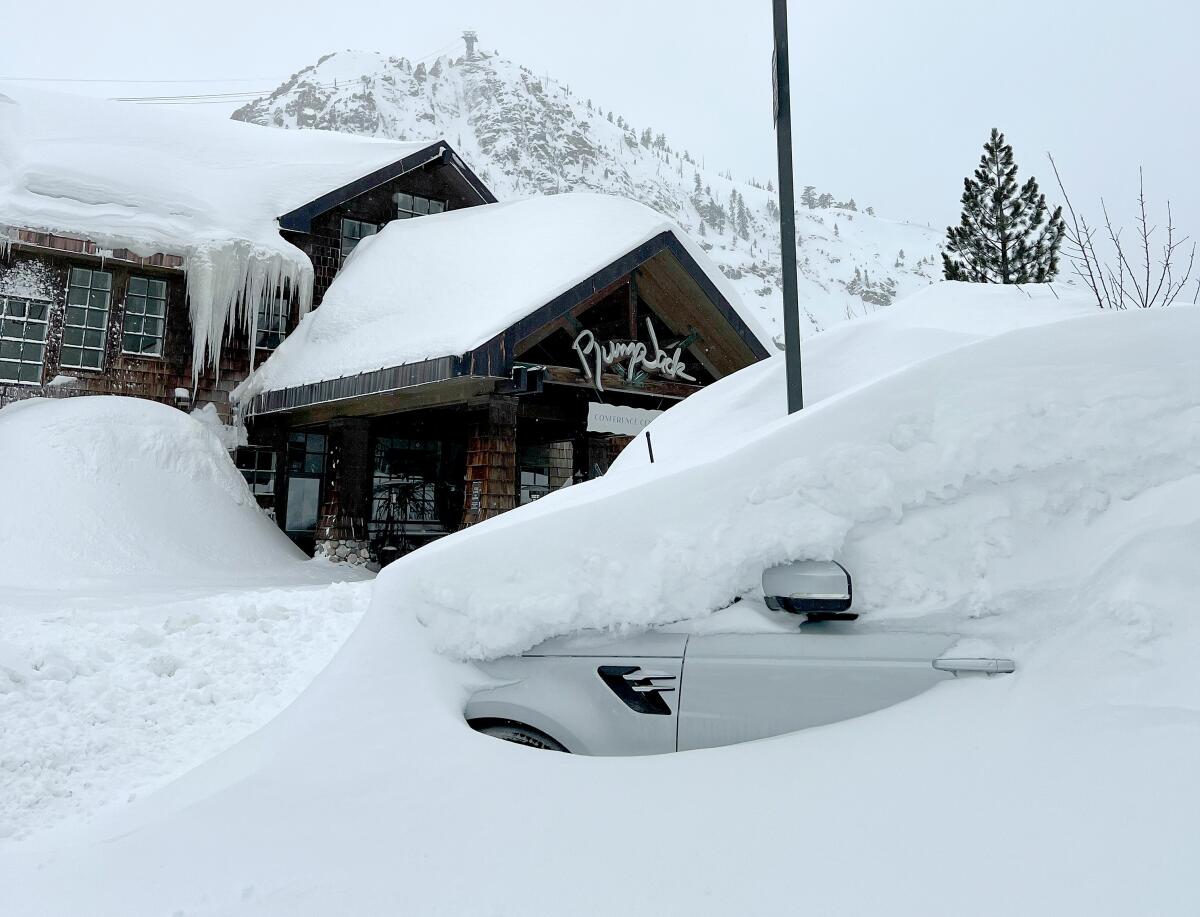 A car is buried under snow at Palisades Tahoe ski resort on Monday.