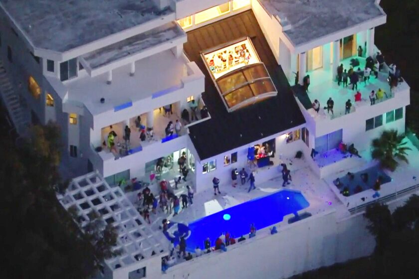 Aerial view of a large house party on Mulholland Drive in Beverly Crest, where three people were shot.