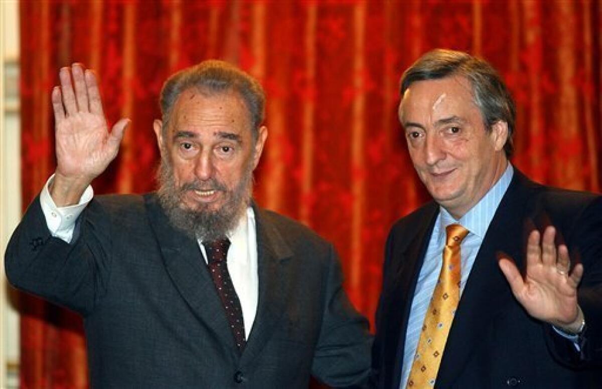 FILE - In this May 26, 2003 file photo, Argentina's President Nestor Kirchner, right, and Cuba's President Fidel Castro wave at the government palace in Buenos Aires, Argentina. According to state television in Argentina, Nestor Kirchner died on Wednesday Oct. 27, 2010 after suffering heart attacks at age 60. (AP Photo/Jorge Saenz, File)