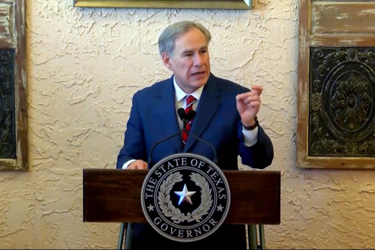 Texas Gov. Greg Abbott speaks from a lectern.