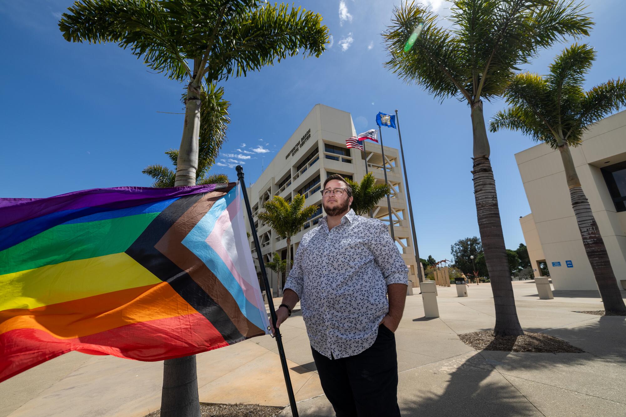 Kanan Durham holds his Pride flag at the Huntington Beach civic center on March 15.