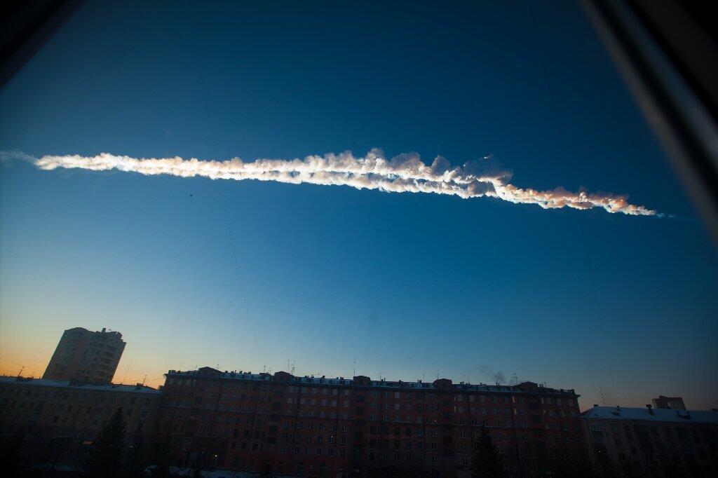 A meteor's contrail is seen over Chelyabinsk, Russia, on Feb. 15, 2013. The streaking meteor caused sharp explosions that injured hundreds of people, including many hurt by broken glass.
