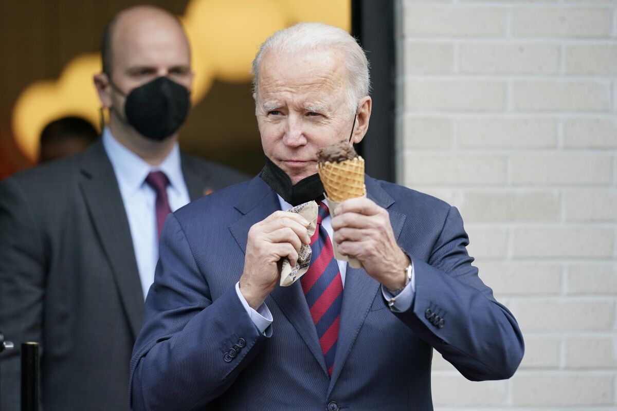 President Biden, cone in hand, leaves an ice cream shop in Washington. 