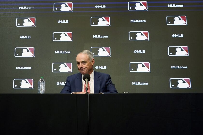 Major League Baseball commissioner Rob Manfred pauses during a news conference in Arlington, Texas, Thursday, Dec. 2, 2021. Owners locked out players at 12:01 a.m. Thursday following the expiration of the sport's five-year collective bargaining agreement. (AP Photo/LM Otero)