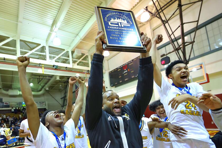 King/Drew coach Lloyd Webster and players celebrate City Section Open Division championship.