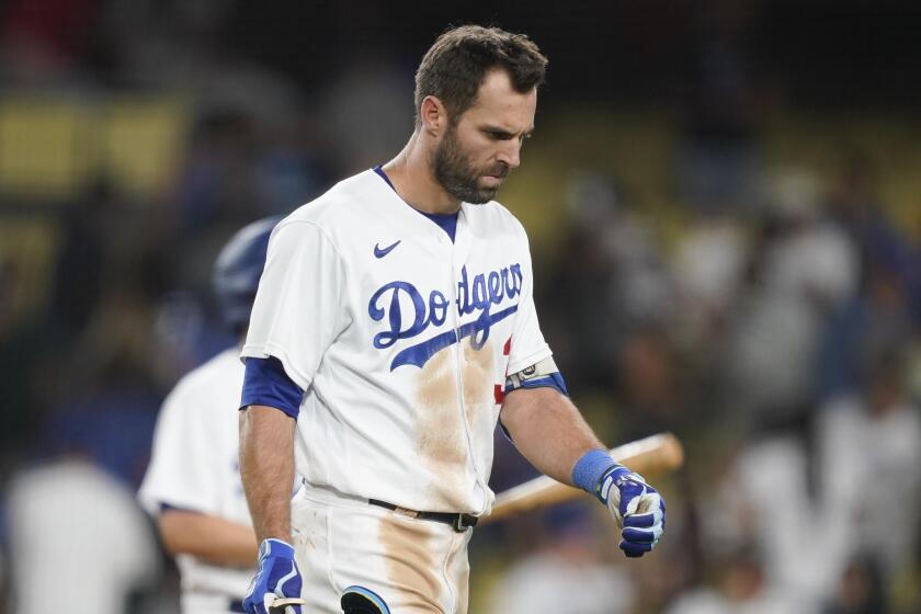 Los Angeles Dodgers' Chris Taylor walks off the field after the team's loss.