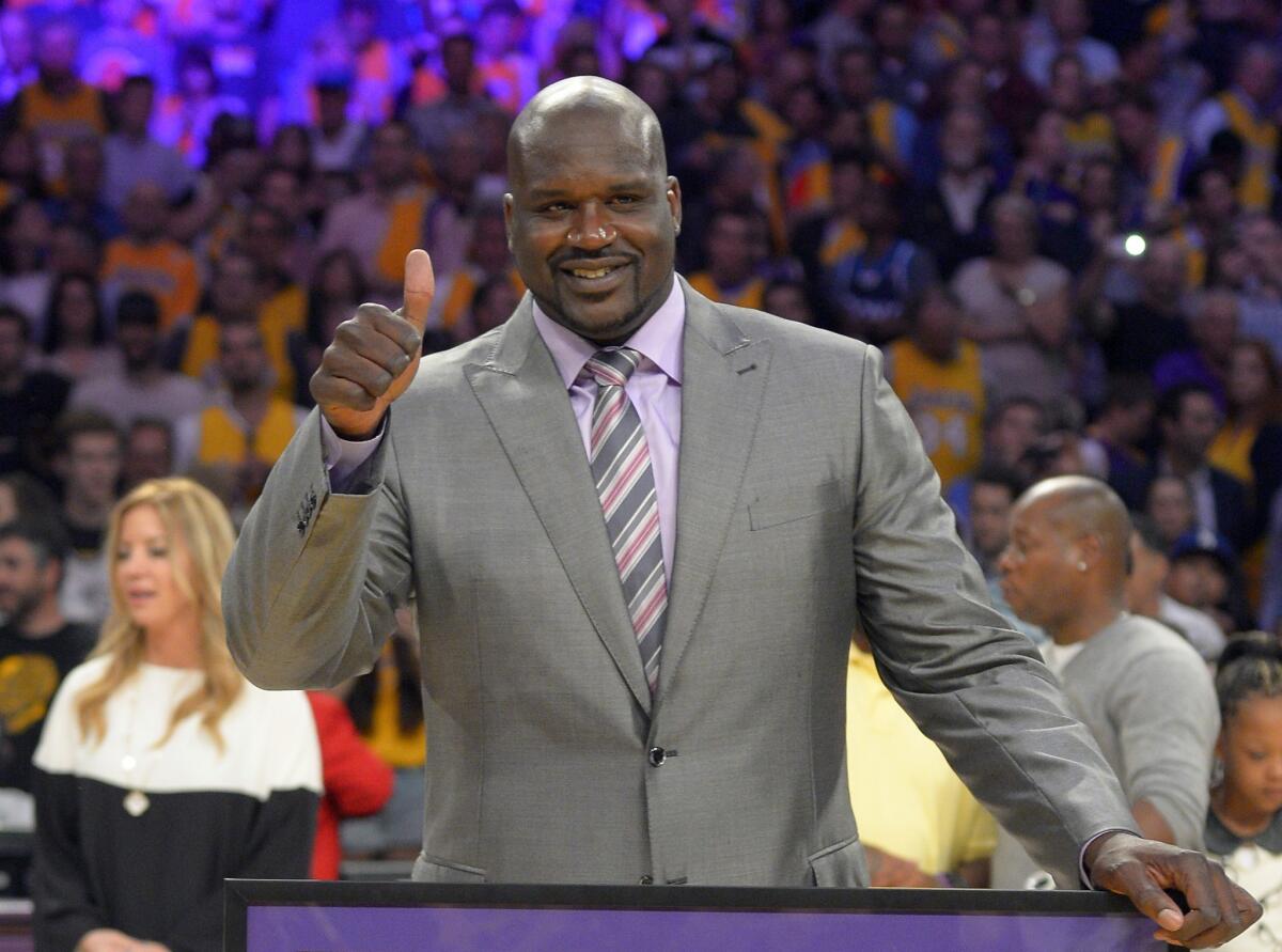 Shaquille O'Neal, shown during his Lakers jersey retirement ceremony, has become a minority owner of the Sacramento Kings.