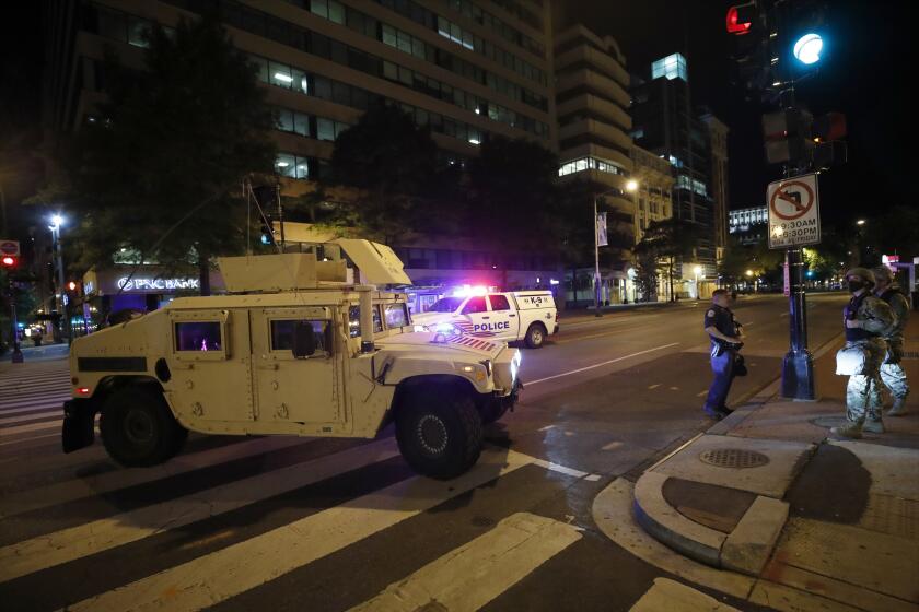 A military Humvee blocks an intersection along K Street in downtown Washington as demonstrators protest the death of George Floyd, Monday, June 1, 2020, in Washington. Floyd died after being restrained by Minneapolis police officers. (AP Photo/Alex Brandon)