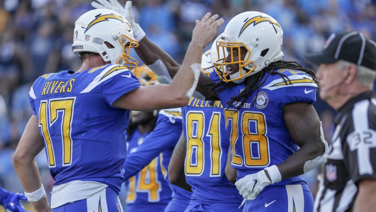 Melvin Gordon and Philip Rivers celebrate on the sideline after Gordon scored on a 28-yard run.
