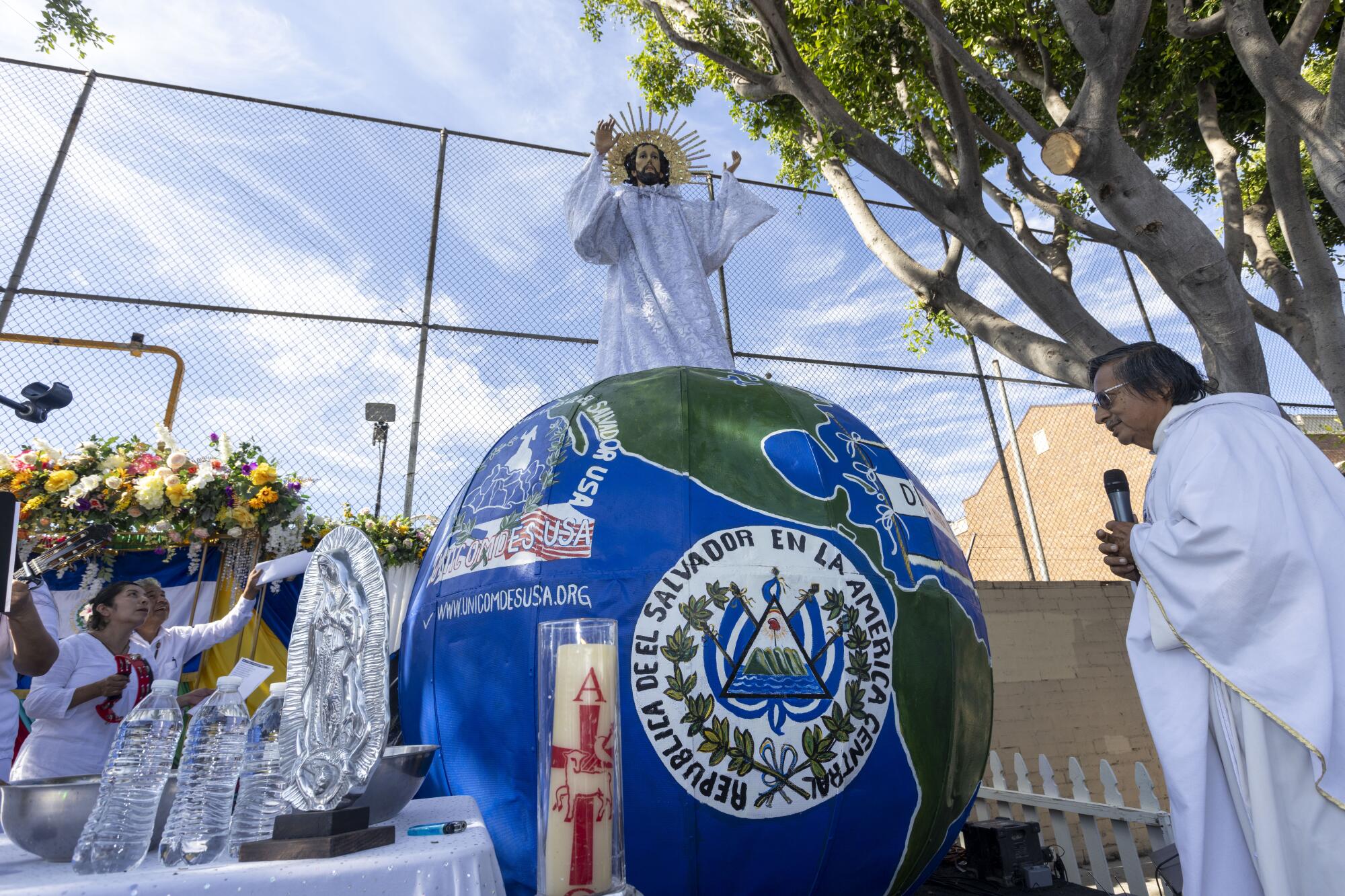 The Jesus figure reappears wearing white as Father Tomas Lopez performs