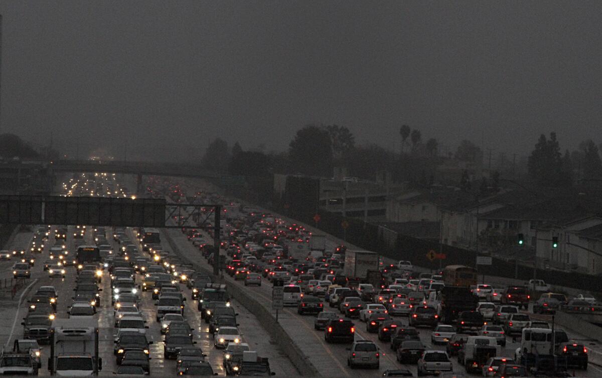 Traffic backed up on the 405 Freeway early this month beneath a steady Southern California rain.