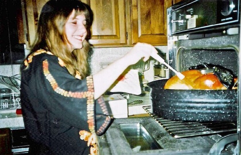 Author Janet Fitch bastes a turkey in her mother's kitchen in the mid-1990s.