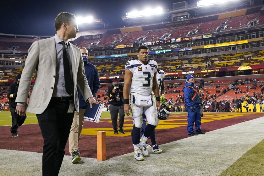 Seattle Seahawks quarterback Russell Wilson walks off the field at the end of an NFL football game against the Washington Football Team, Monday, Nov. 29, 2021, in Landover, Md. Washington won 17-15. (AP Photo/Julio Cortez)