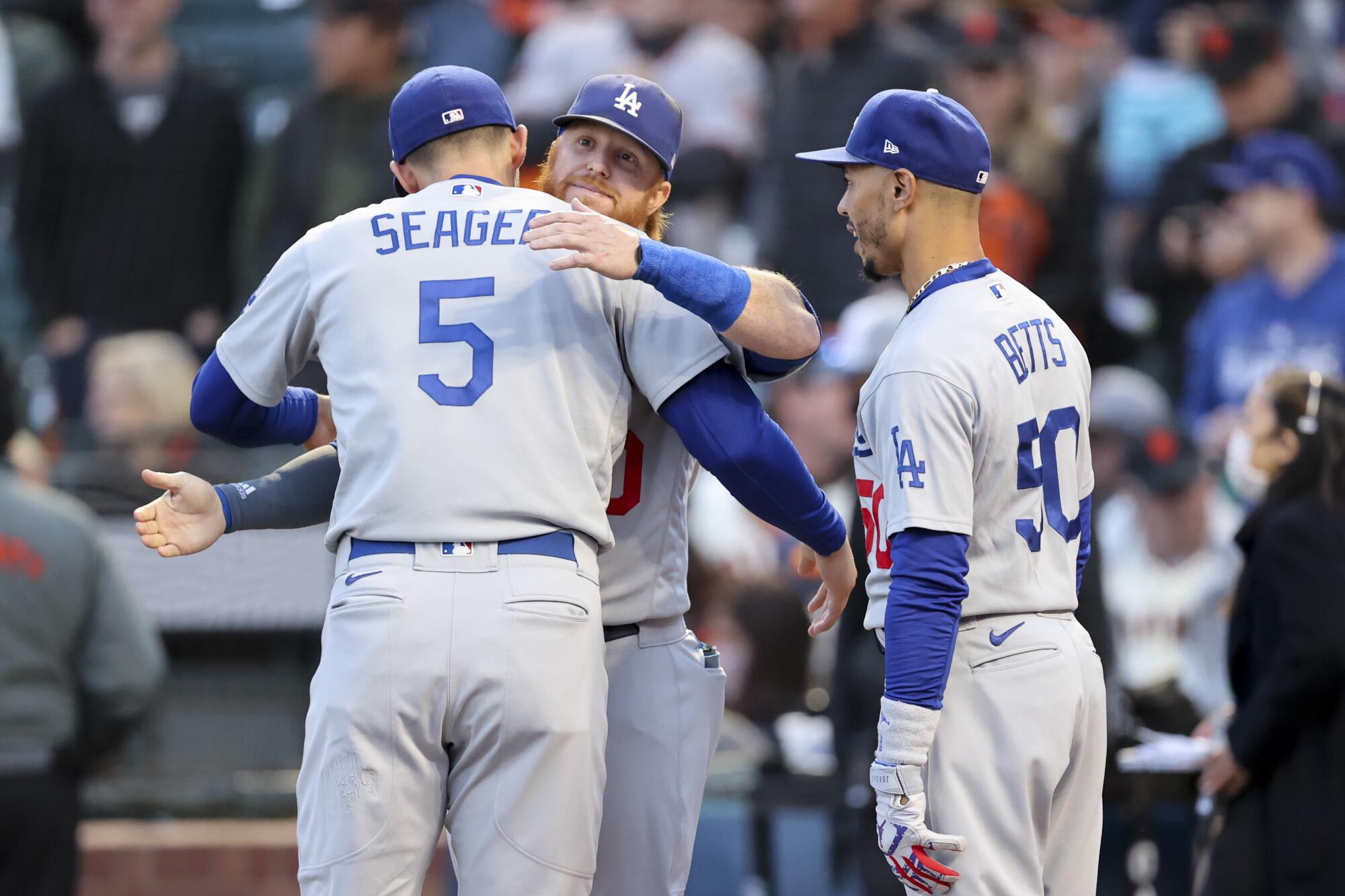  Dodgers' Corey Seager, left, embraces Justin Turner before the game.