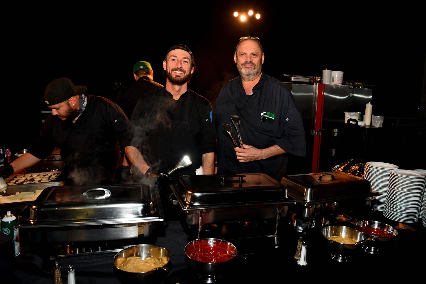 Pamplemousse Grille owner and chef Jeffrey Strauss (right) and staff serve late-night treats during the La Jolla Playhouse Gala after-party.