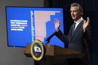 California Gov. Gavin Newsom displays a chart aimed at refuting critics of California's laws dealing with property crime during a news conference where he unveiled his proposed state budget for the 2024-2025 fiscal year, in Sacramento, Calif., Wednesday, Jan. 10, 2024. (AP Photo/Rich Pedroncelli)