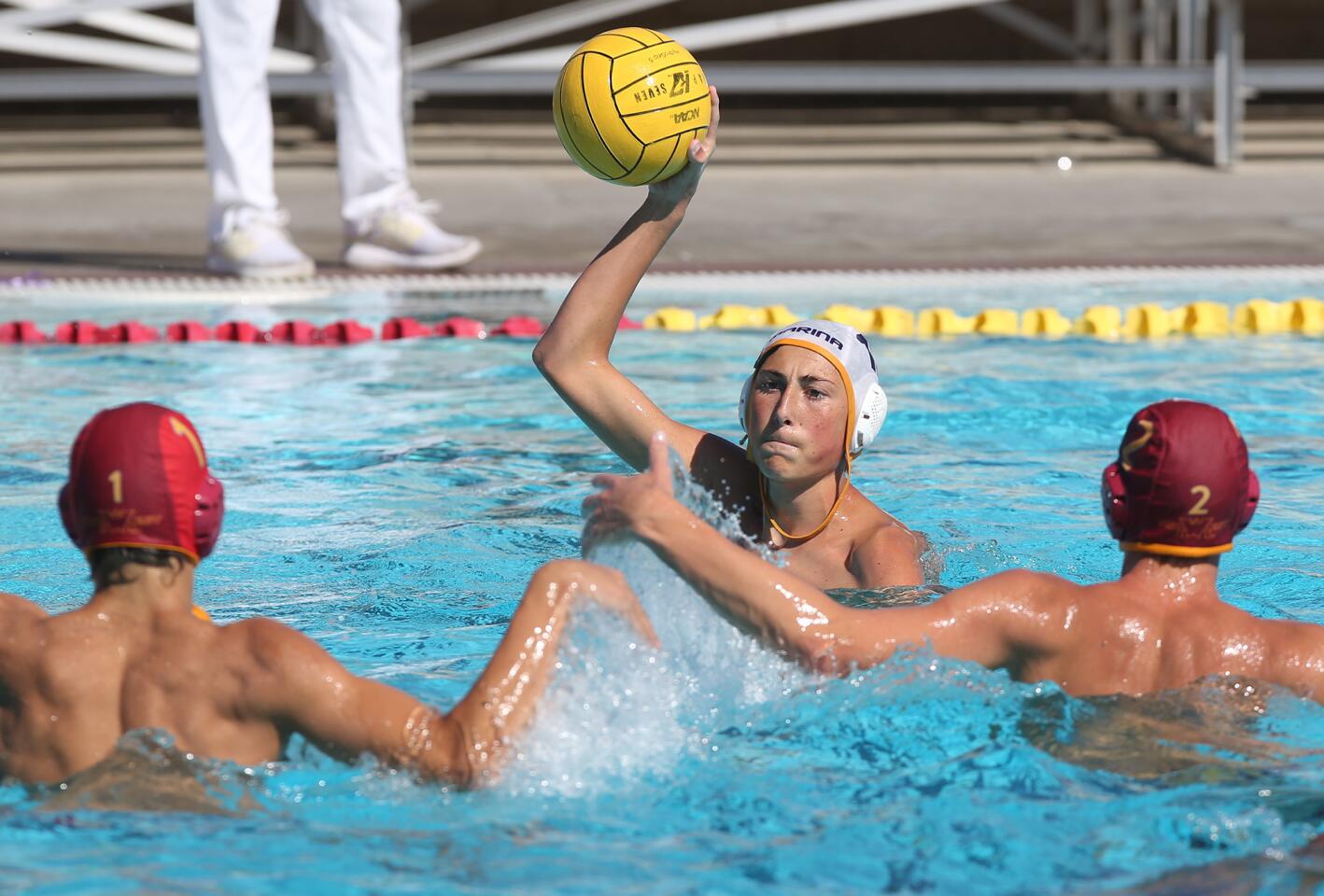 Marina's Vincent Labonte looks to shoot as Ocean View defenders close in during non league waterpolo game on Thursday.