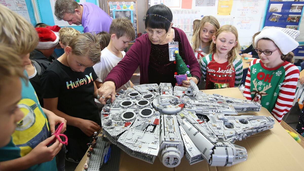 Art teacher Jeanna Bassett looks at her rebuilt Star Wars Millennium Falcon spaceship, which is made of Legos, after it was damaged by vandals at Concordia Elementary in San Clemente.