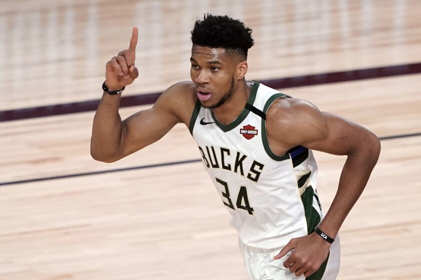 Bucks star Giannis Antetokounmpo celebrates after a dunk against the Magic during a game last season.