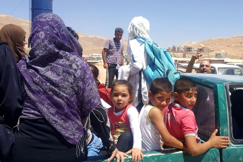 Syrian refugees arrive in Wadi Hamayyed, on the outskirts of Lebanon's northeastern border town of Arsal, to board buses bound for the northwestern Syrian town of Idlib on August 2, 2017. / AFP PHOTO / STRINGERSTRINGER/AFP/Getty Images ** OUTS - ELSENT, FPG, CM - OUTS * NM, PH, VA if sourced by CT, LA or MoD **