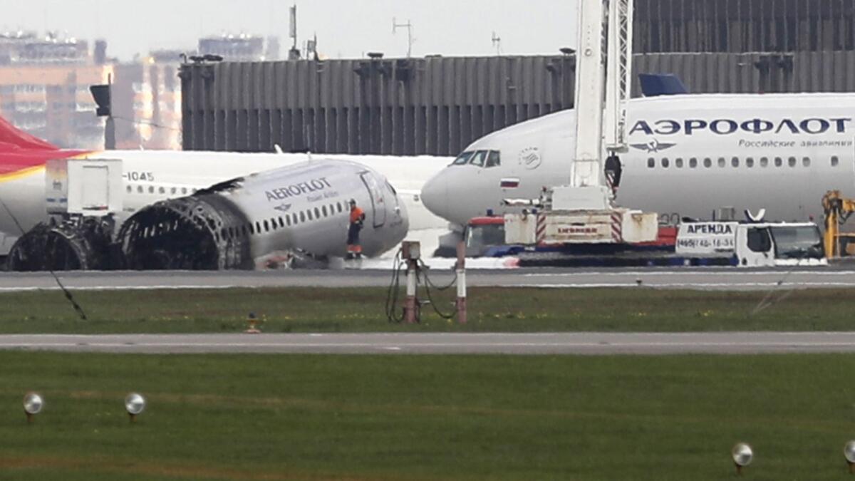 An Aeroflot Sukhoi Superjet 100 sits on the tarmac after the plane crash-landed at Sheremetyevo airport in Moscow in May.