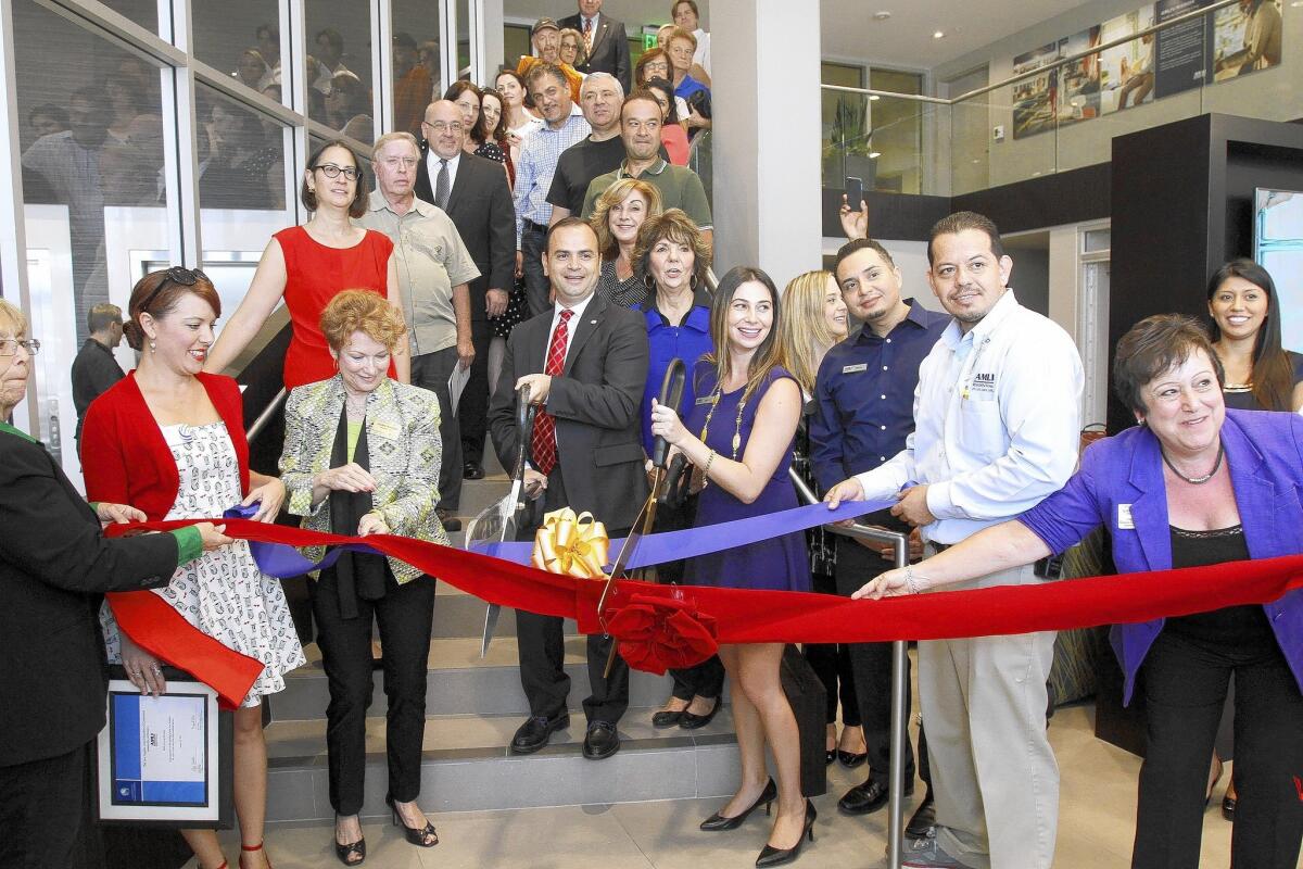 With the help of two local chambers of commerce and Glendale mayor Zareh Sinanyan, center, and others, the residential complex Lex on Orange had its grand opening ceremony at its location on the 300 block of N. Orange St. in Glendale on Tuesday, Aug. 26, 2014.