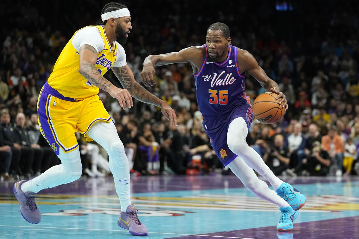 Suns forward Kevin Durant drives on Lakers forward Anthony Davis in a game on Nov. 10, 2023, in Phoenix.