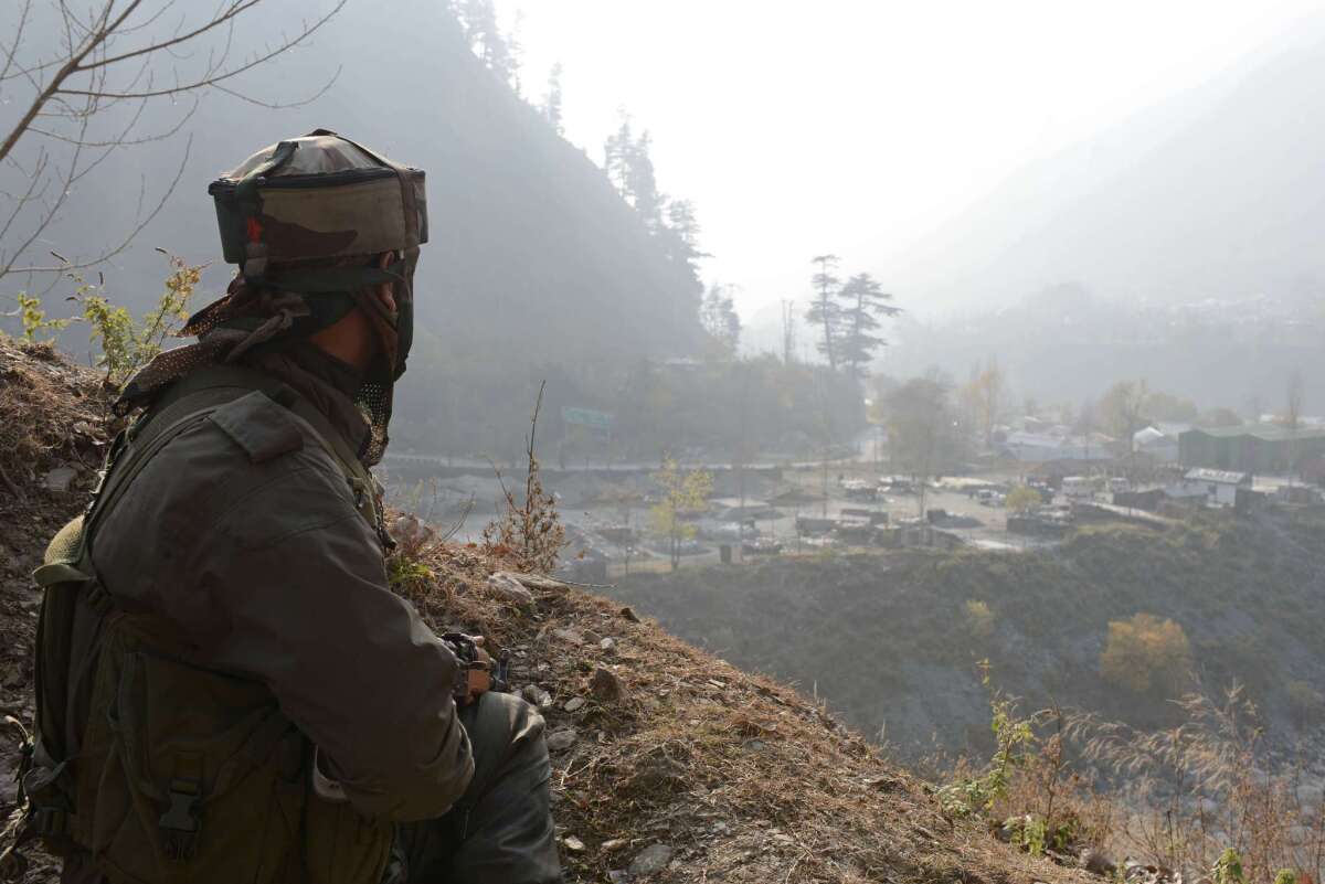 An Indian soldier keeps watch Friday at a camp in Gingal Uri, in the disputed Kashmir region, after coordinated attacks by suspected Pakistani militants left 21 people dead.