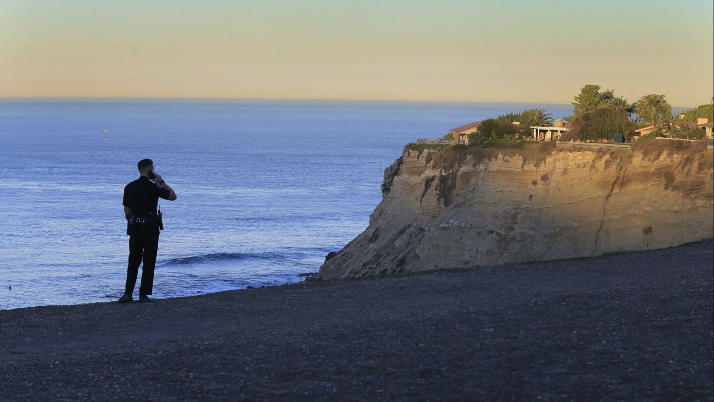 A Palos Verdes Estates police officer watches for trouble at Lunada Bay, where local surfers have clashed with outsiders.