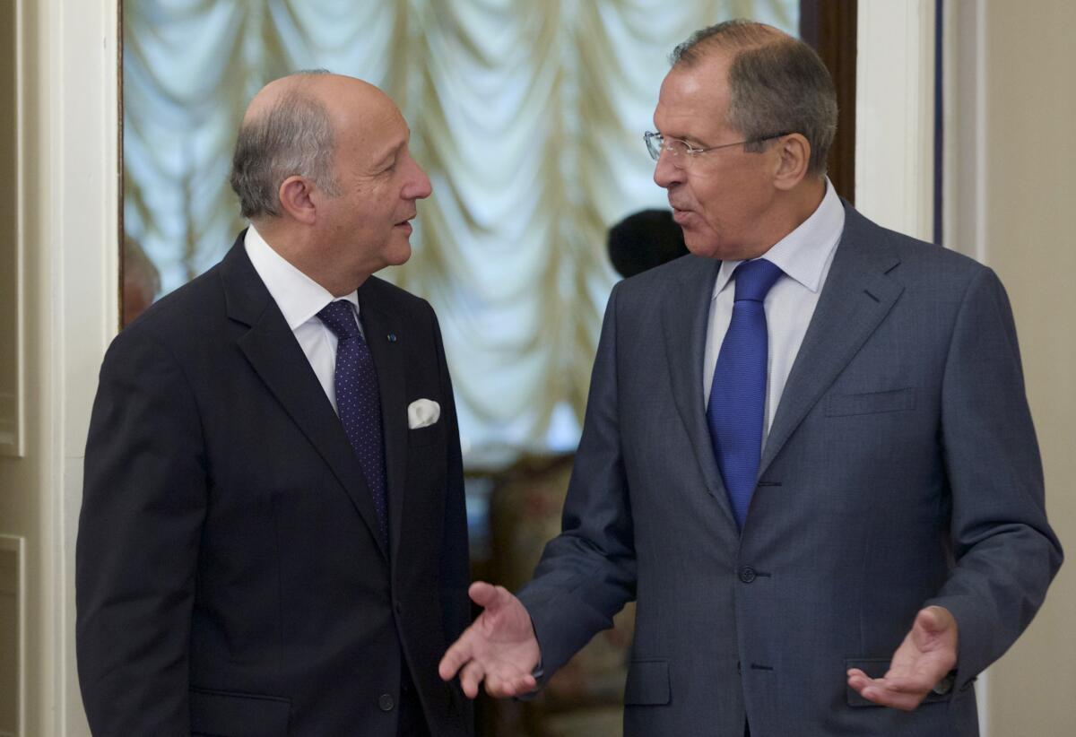 Russian Foreign Minister Sergei Lavrov, right, greets his French counterpart, Laurent Fabius, before a meeting in Moscow.