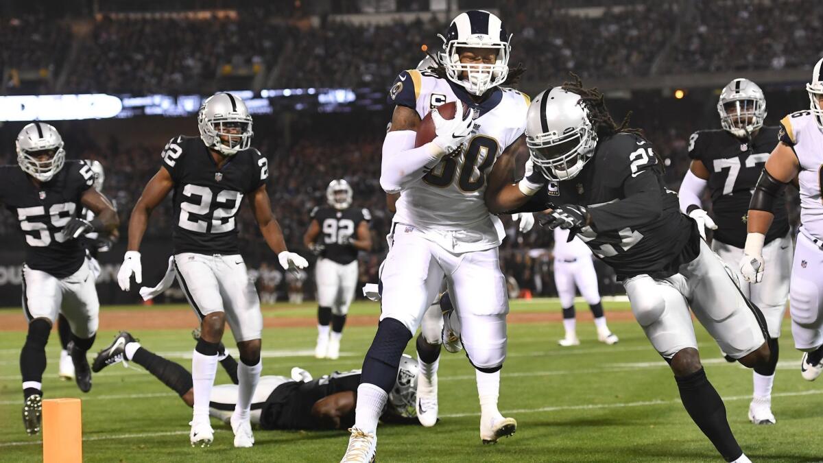 Rams running back Todd Gurley beats the Oakland Raiders defense to the end zone in the first quarter at the Oakland Coliseum on Monday.
