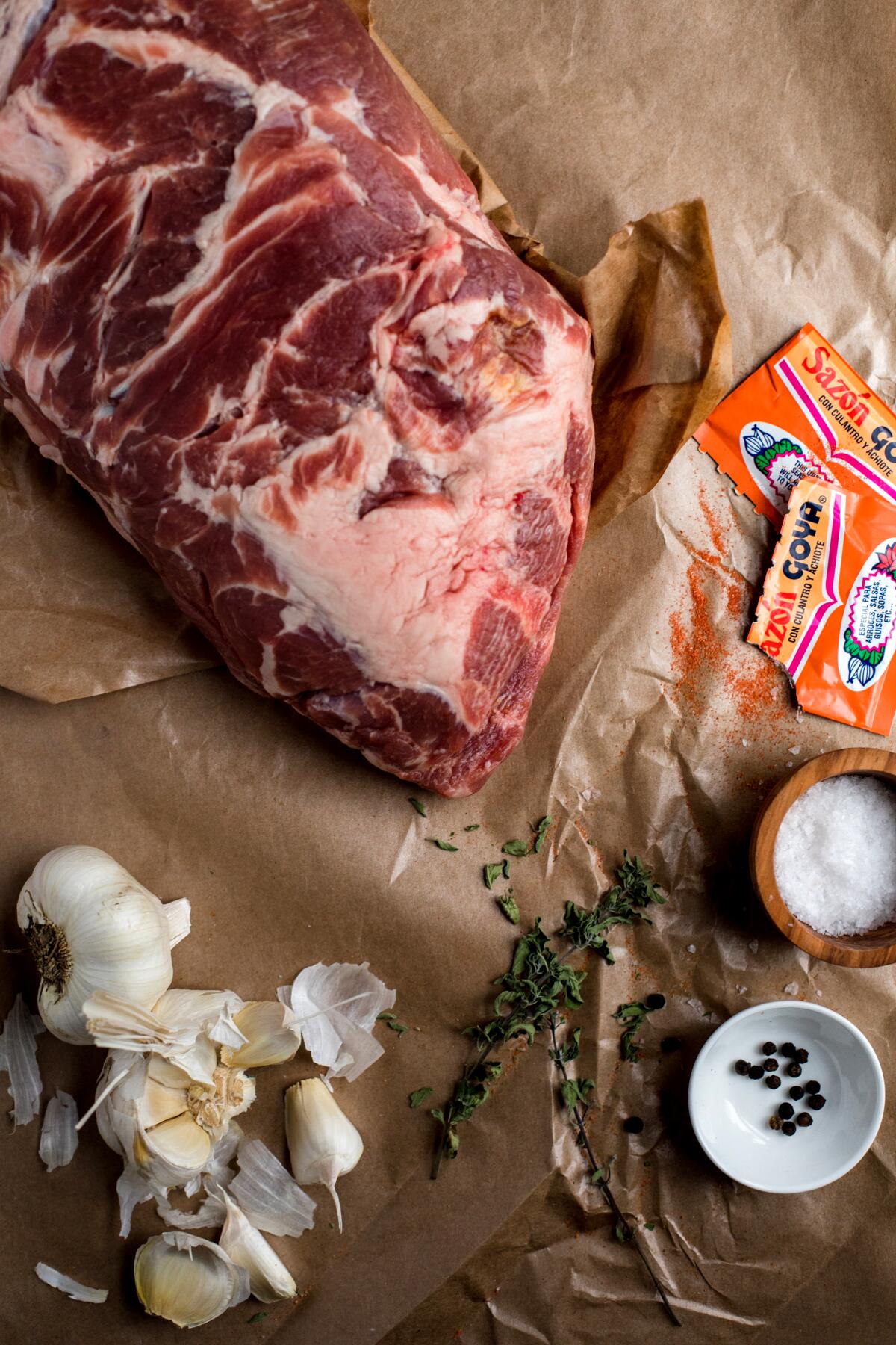 Pernil ingredients: bone-in pork butt, dried oregano, Goya Sazon Culantro y Achiote, garlic, salt and pepper