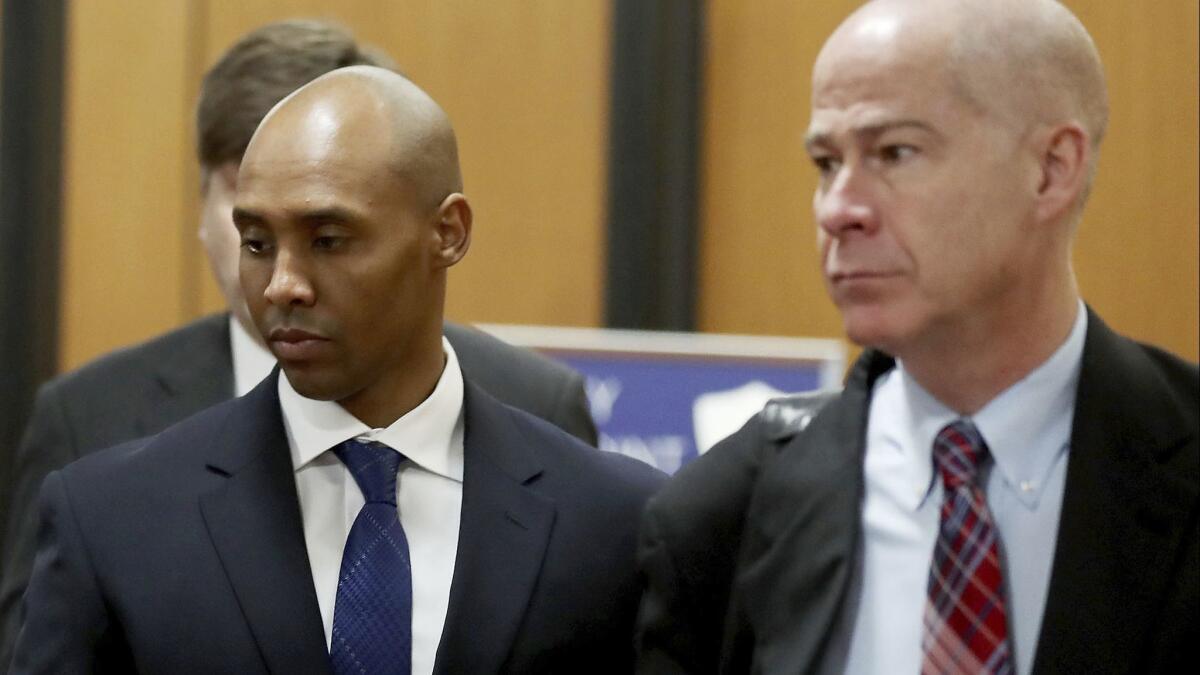 Former Minneapolis police officer Mohamed Noor is accompanied by his attorney Thomas Plunkett, right, as he walks to court for opening arguments of his trial April 9 in Minneapolis.