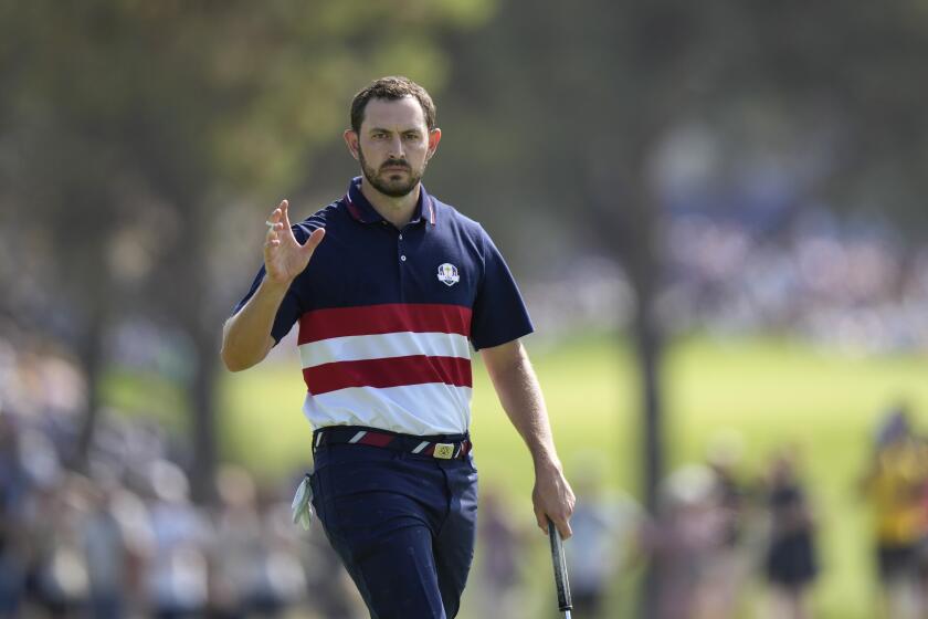 United States' Patrick Cantlay reacts to the crowd on the 1st green during their singles match at the Ryder Cup golf tournament at the Marco Simone Golf Club in Guidonia Montecelio, Italy, Sunday, Oct. 1, 2023. (AP Photo/Andrew Medichini)