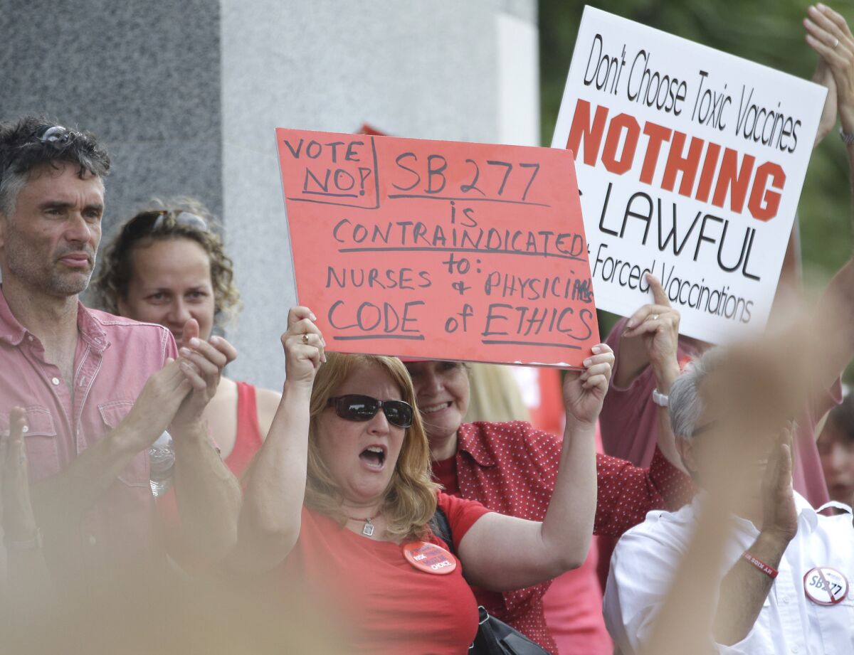 Protesters rally earlier this month in Sacramento against SB 277, the bill eliminating personal belief exemptions for vaccinations. (Rich Pedroncelli/AP)