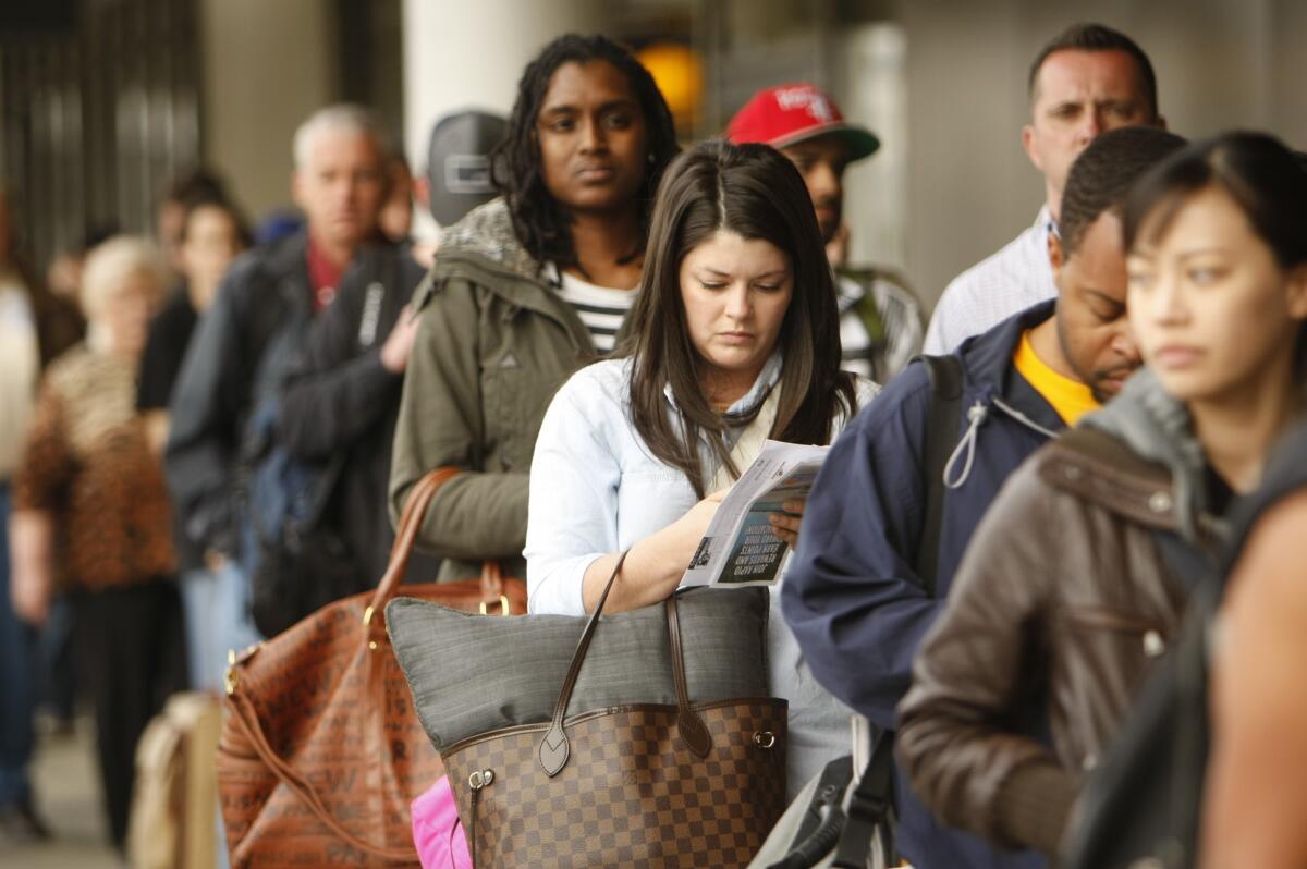 Passengers wait to go through security screening outside Terminal 1 at Los Angeles International Airport.