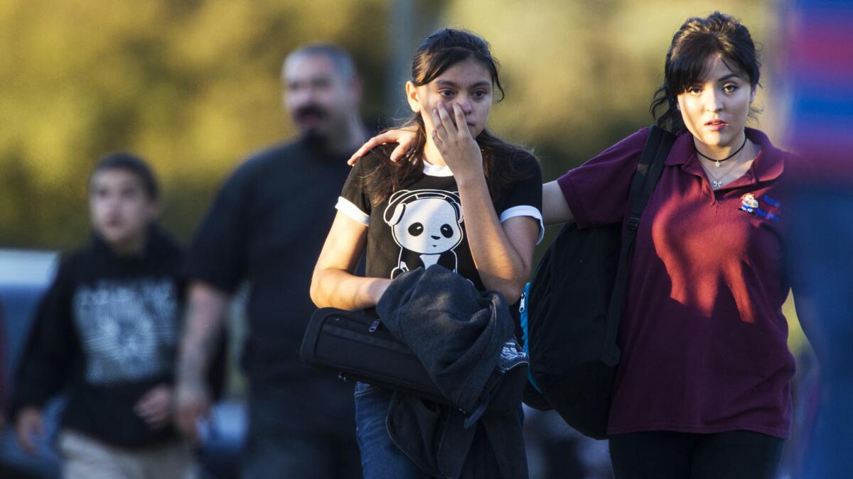 Parents evacuate their children after Slauson Middle School was placed on lockdown.