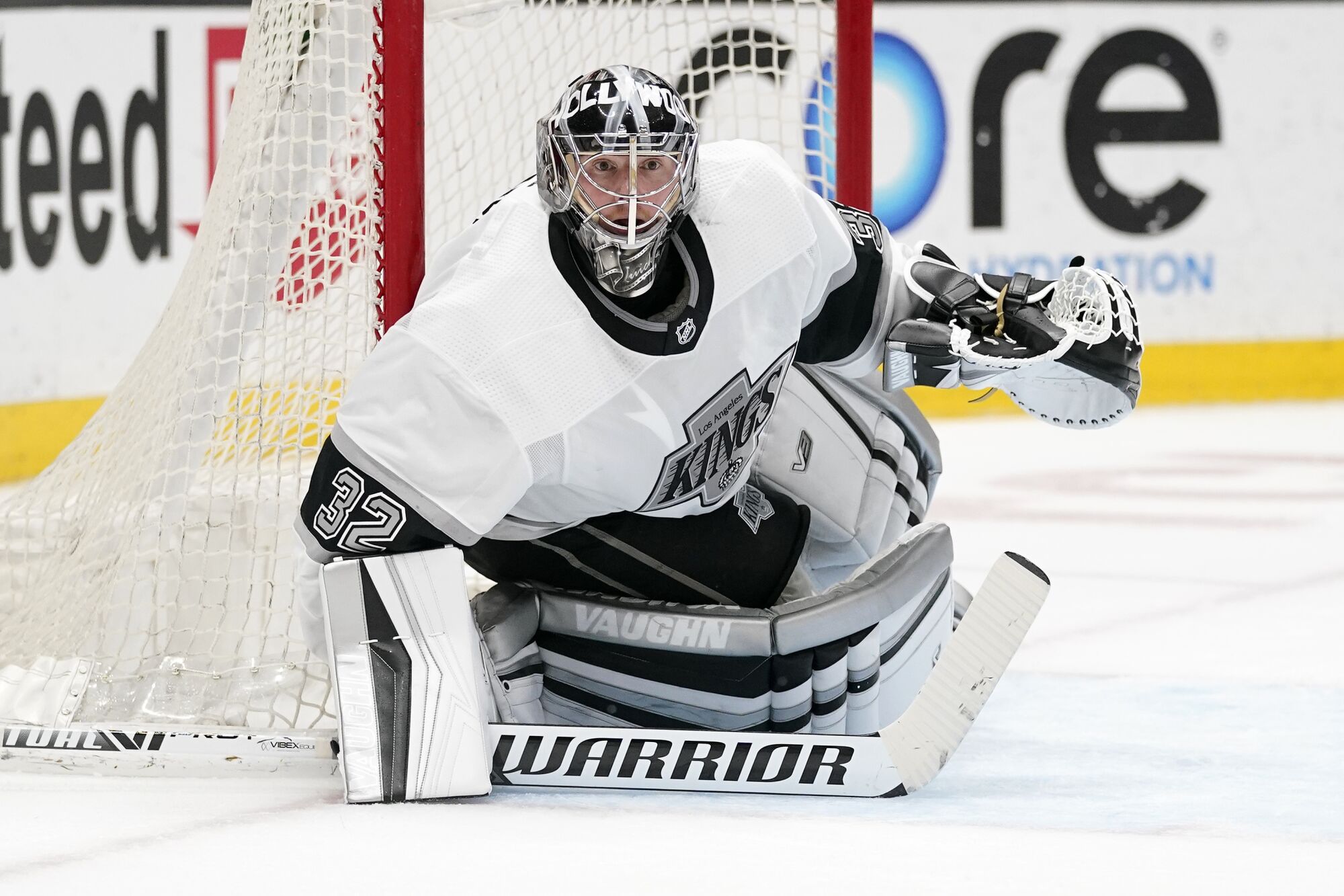 Kings goaltender Jonathan Quick crouches in goal and looks across the ice