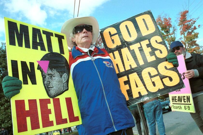 The Rev. Fred Phelps of Westboro Baptist Church protests in October 1999 about a meeting between the Rev. Jerry Falwell and the Rev. Mel White in Lynchburg, Va. Falwell met with White and other gay Christians in an attempt to reduce violent acts against both groups.