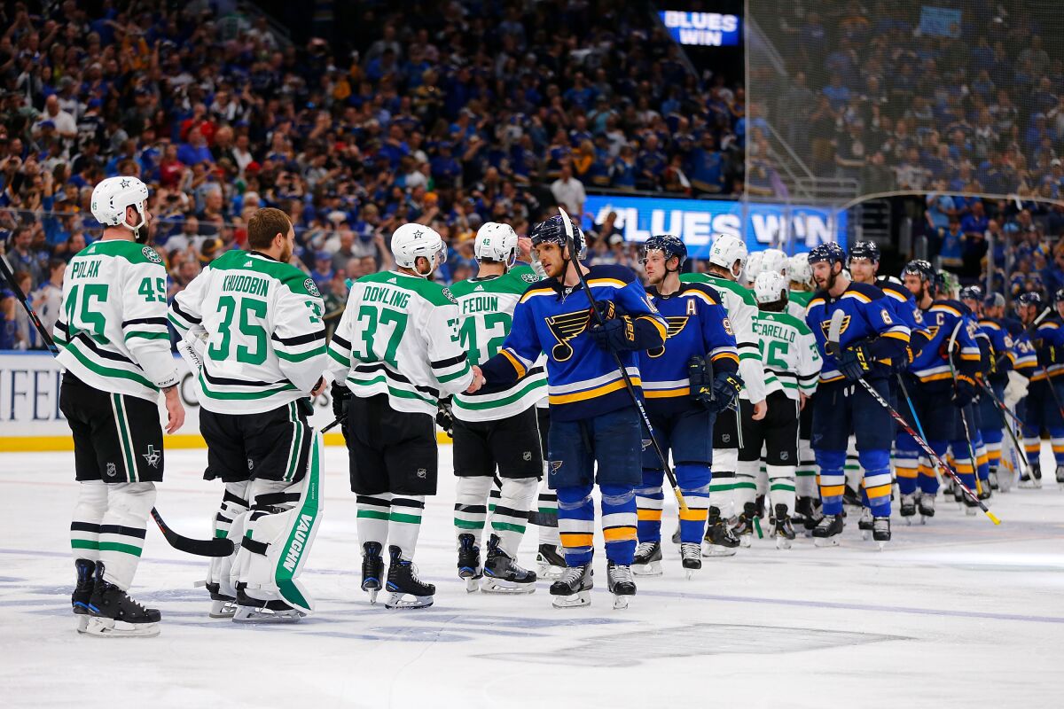 Players on the Dallas Stars and St. Louis Blues take part in the traditional post-playoff series handshake following the Blues' win in Game 7 of the Western Conference semifinals in May 2019.