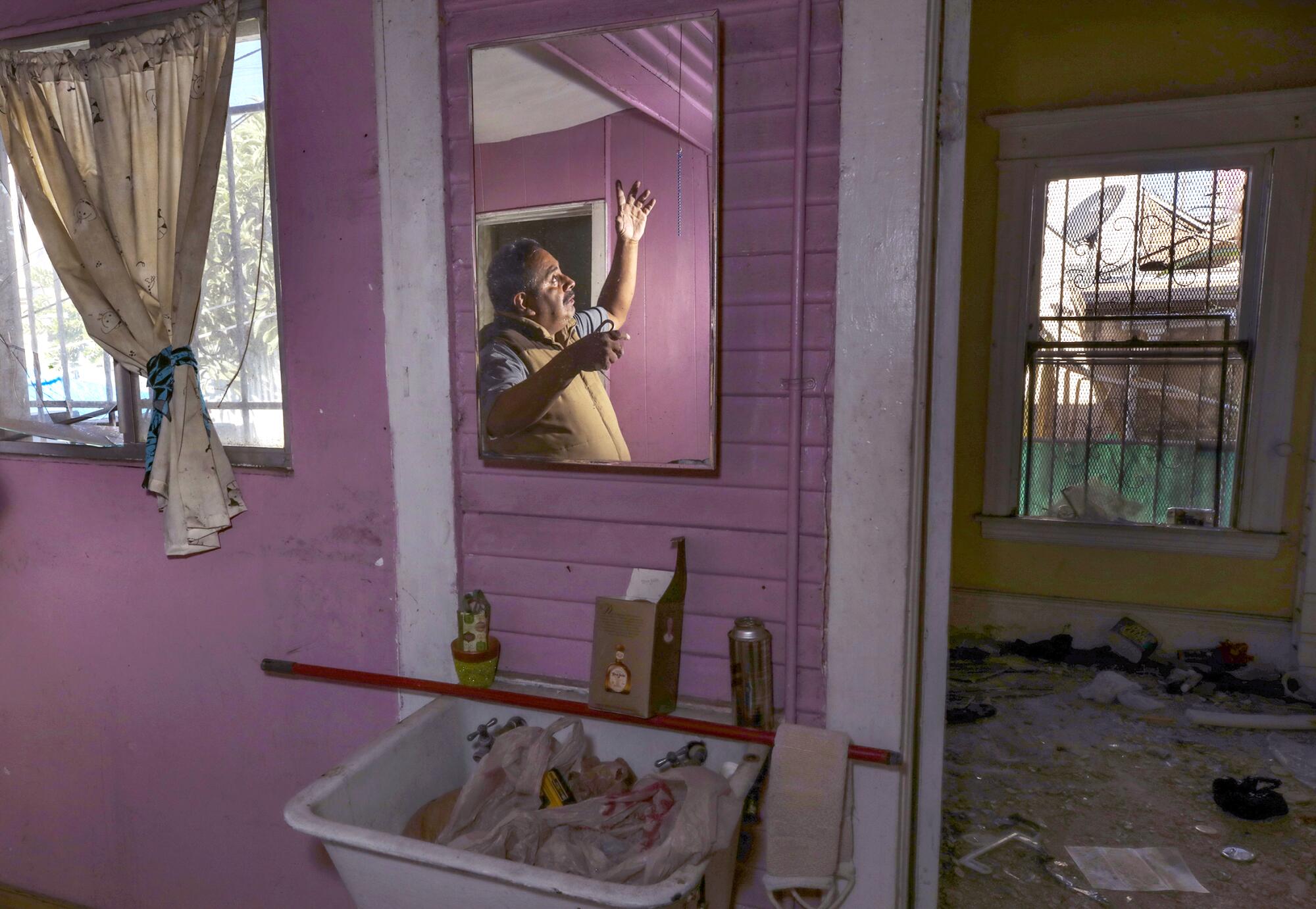 Jose Becerra inside his wrecked home in the 700 block of East 27th Street.