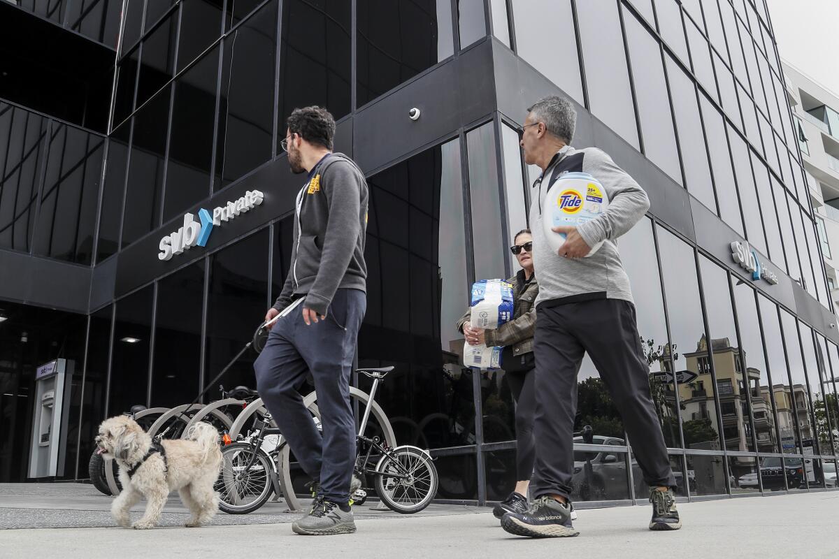 Pedestrians walking past Silicon Valley Bank branch in Santa Monica
