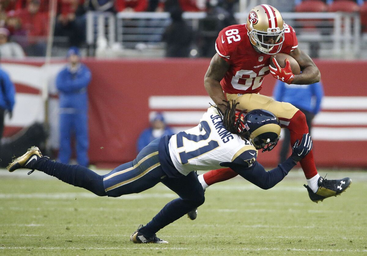 San Francisco receiver Torrey Smith (82) tries to jump over Rams cornerback Janoris Jenkins (21) during overtime of a game on Jan. 3.