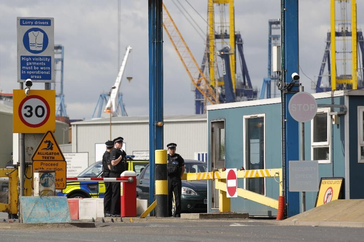 Police stand guard at an entrance to Tilbury Docks, east of London.